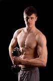 Young muscular man training with dumbbell