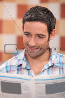 35 years old man reading newspaper