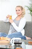Woman having breakfast in her living room