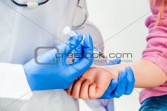 Doctor doing vaccine injection to a child