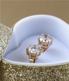 gold earrings stud with diamonds in a gold box