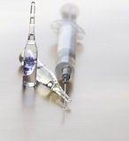 Close-up of vaccine drop on syringe needle