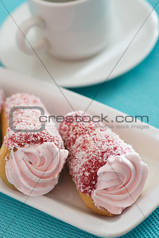 Two cakes with pink cream on a blue background