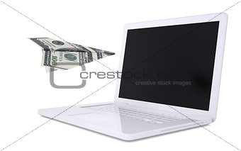 White laptop and the plane of dollars