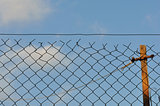 chain link fence and blue sky