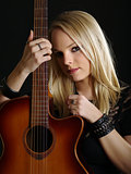 Sexy blond woman with acoustic guitar