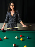 Beautiful brunette playing pool