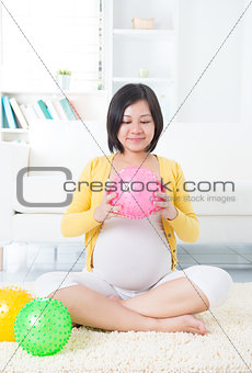 Asian pregnant woman exercising