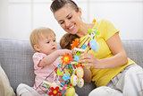 Happy mother and baby making Easter decoration