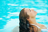 Portrait of young woman relaxing in pool