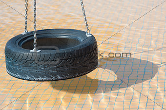 Tyre swing in a swimming pool