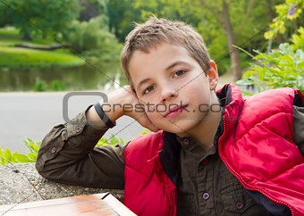 Cute thoughtful teenage boy against green background