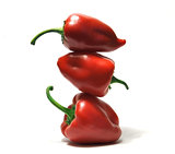 Three fresh red bulgarian peppers standing like a pyramid