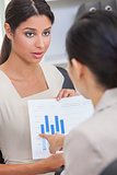 Woman or Businesswoman in Meeting with Graph