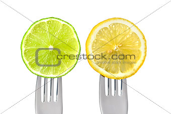 lime and lemon on forks isolated