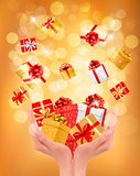 Holiday background with hands holding gift boxes. Concept of giv