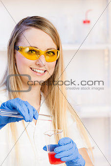 portrait of young woman doing experiment in laboratory