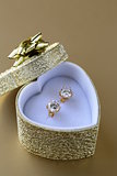 gold earrings stud with diamonds in a gold box