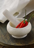 red hot chili peppers in a marble mortar