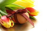 decorated eggs and spring flowers tulips - symbols of Easter holiday