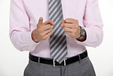 A cropped picture of a businessman counting on his fingers.