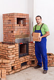 Professional worker building masonry heater