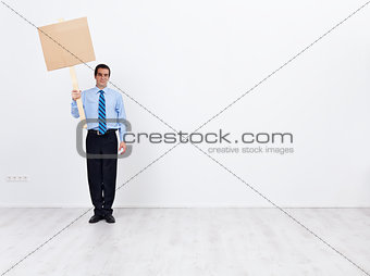 Lonely businessman with placard and lots of copy space