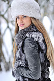 Fur fashion hat. Beautiful girl in furry hat. Winter woman portr