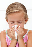 Little girl with the flu blowing nose