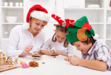 Happy christmas family decorating gingerbread cookies