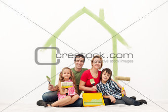 Happy couple with two kids repainting their home
