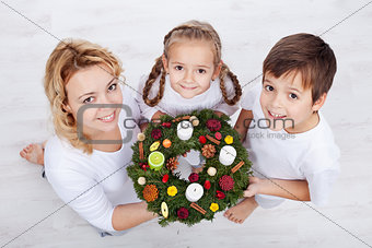 Woman with two kids holding advent wreath