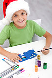 Boy making christmas card