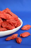 Goji berries also called wolfberries isolated on blue