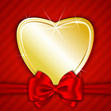 Golden shiny heart on red background
