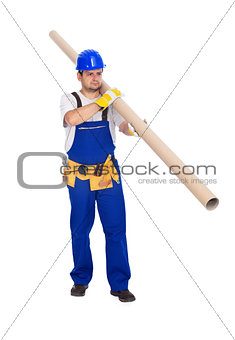 Worker carries long pipe