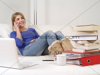 Pretty teenager using smartphone at home