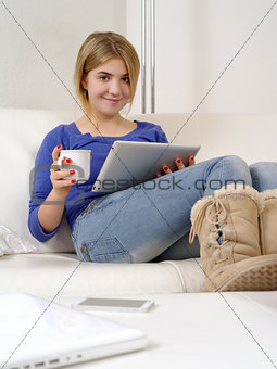 Pretty teenager using a digital tablet