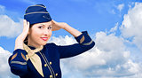 Beautiful  smiling stewardess in uniform on a background sky