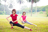 Two Asian girls stretching 