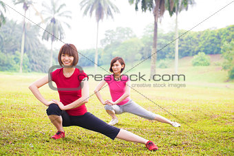 Two Asian girls stretching 