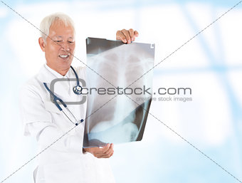 Asian senior doctor checking on x-ray image