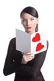 pretty brunette with valentine postcard looks in to the lens
