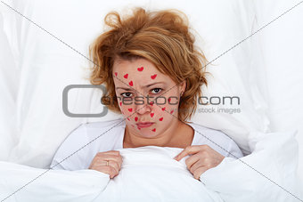 Lovesick woman laying in bed