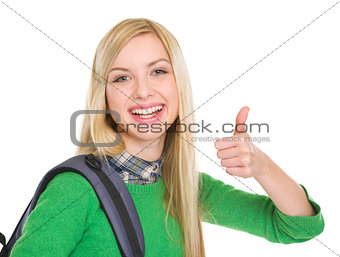 Smiling student girl showing thumbs up