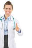 Smiling medical doctor woman showing thumbs up