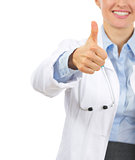 Closeup on smiling medical doctor woman showing thumbs up