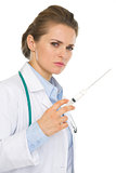 Serious medical doctor woman with syringe
