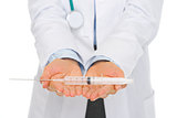 Closeup on syringe in hands of medical doctor