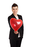 Young man holding heart shape balloon